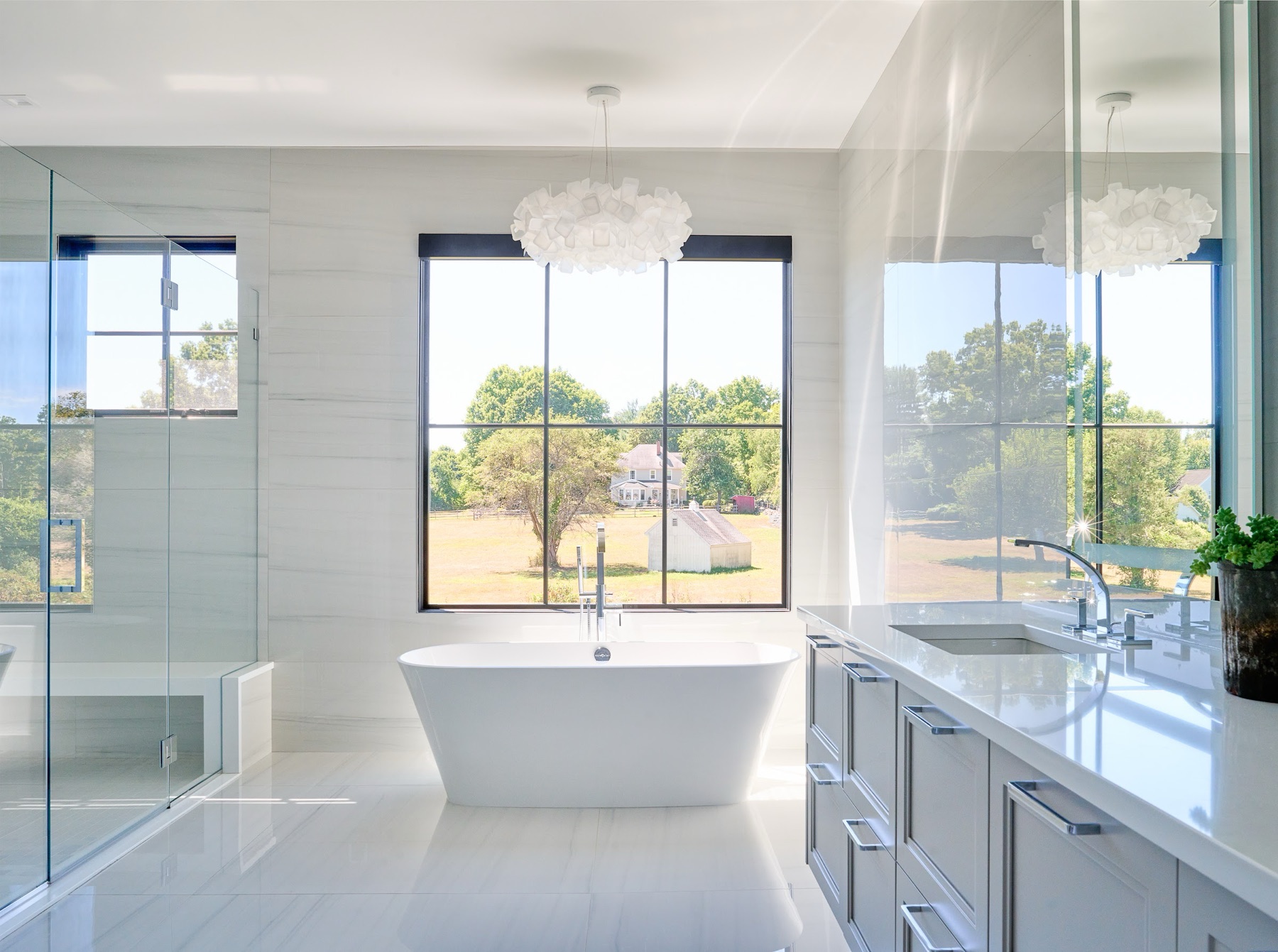 Freestanding tub between tall windows