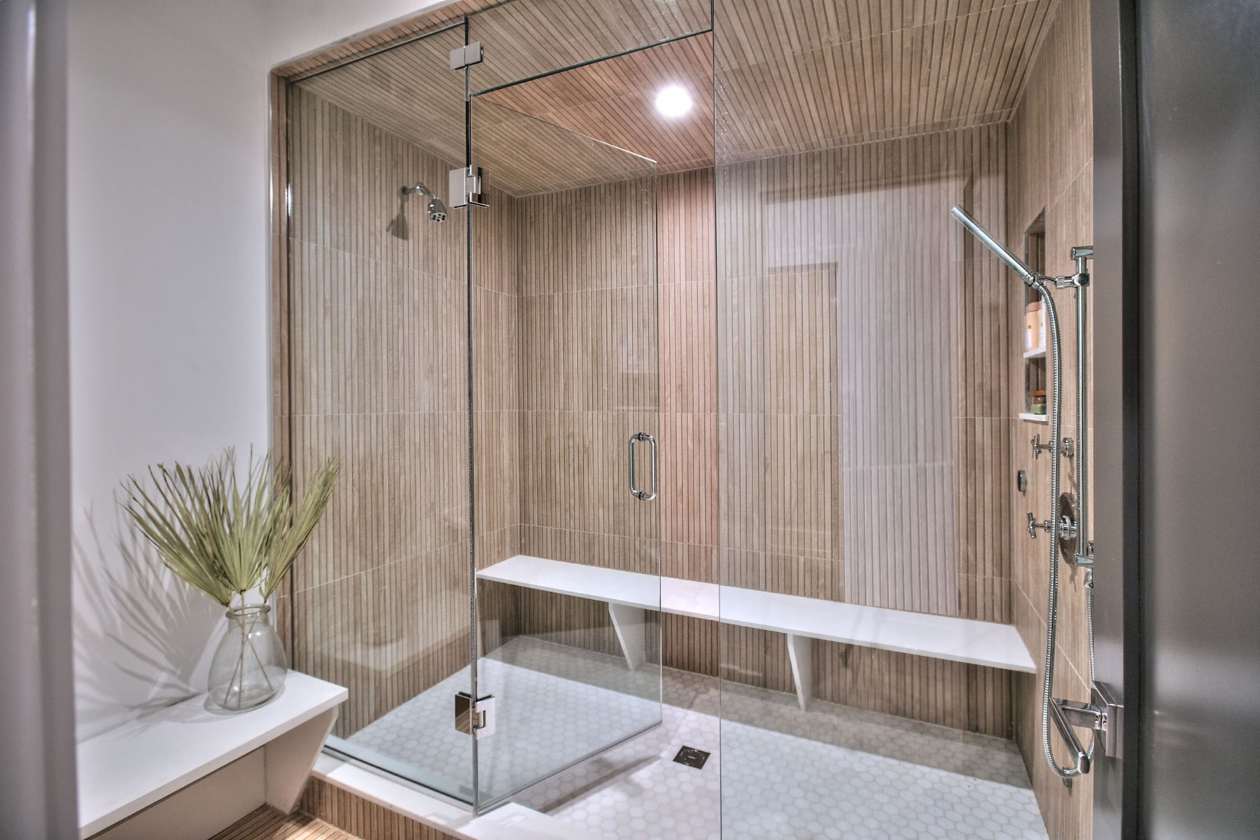 Steam shower with a bench and glass wall