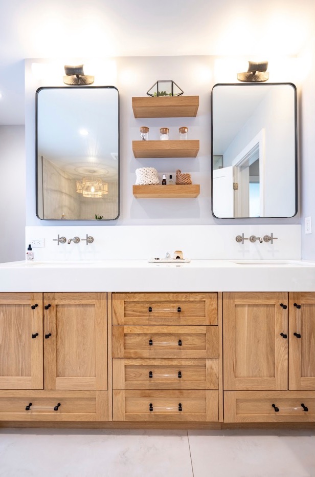 Twin mirrors over an oak vanity