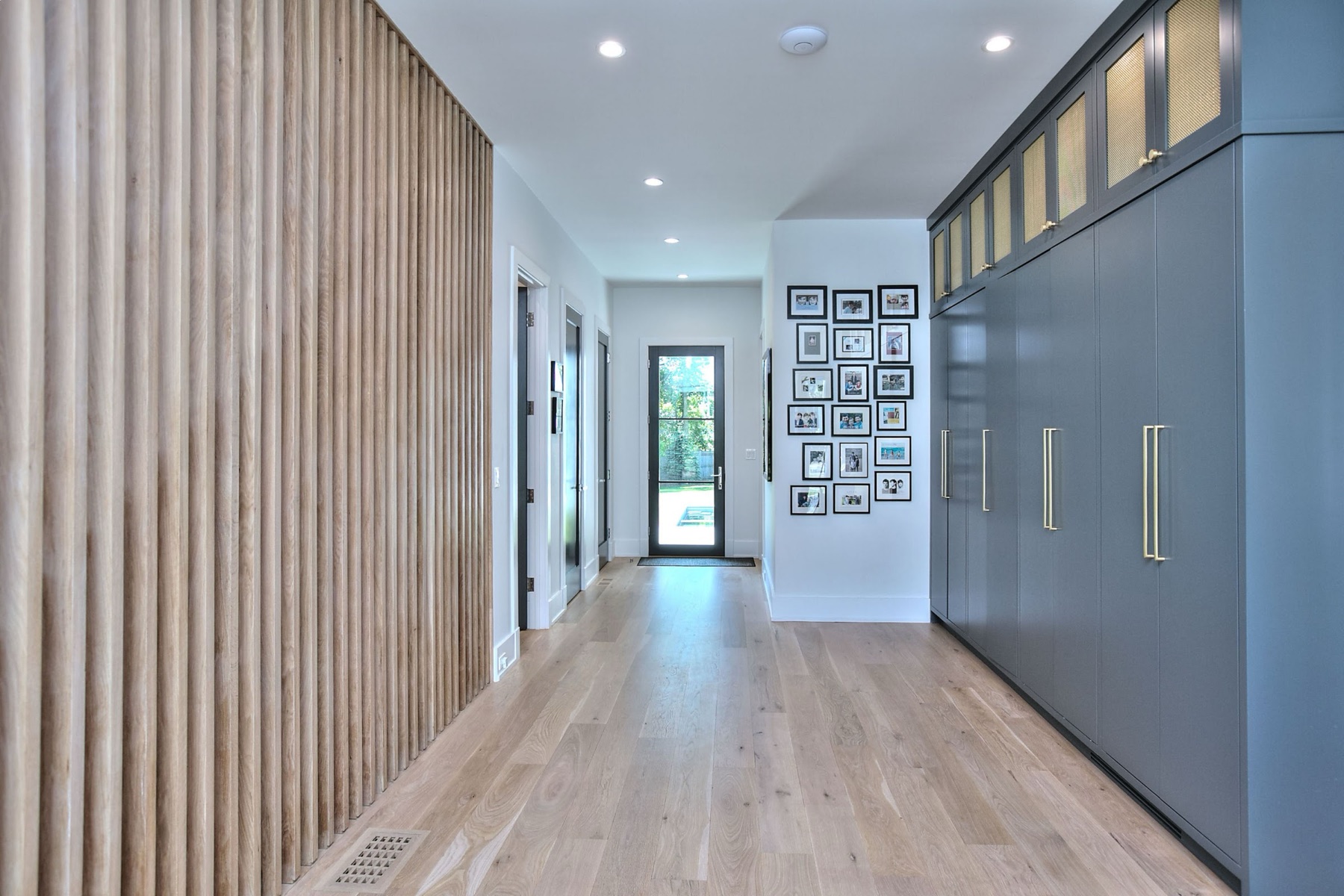 Hallway with fluted wood and a gallery wall