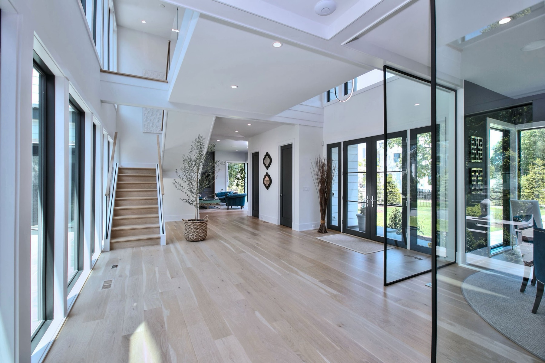 Entry hall with glass walls and a staircase