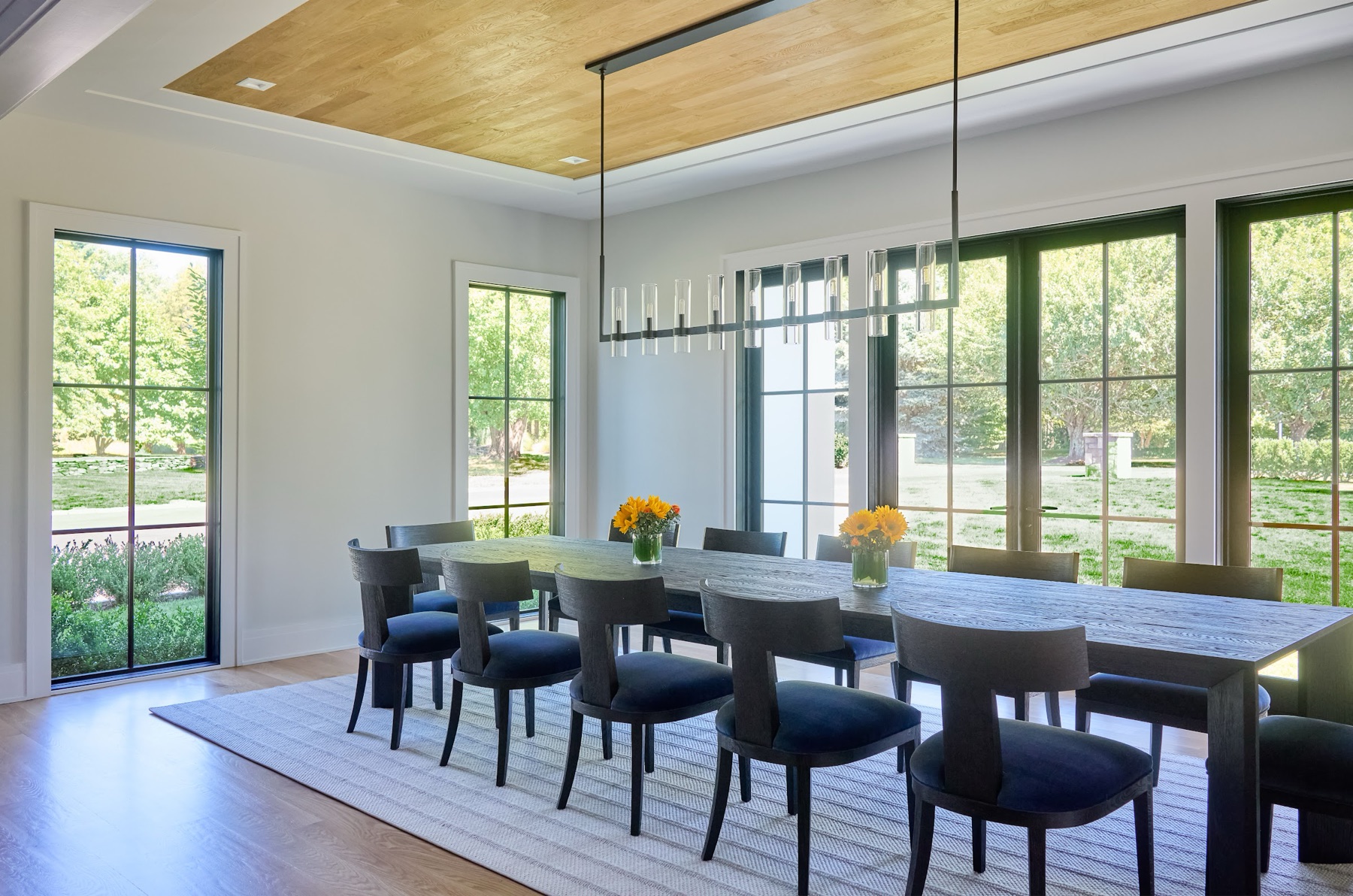 Dining room with a long table and a window wall