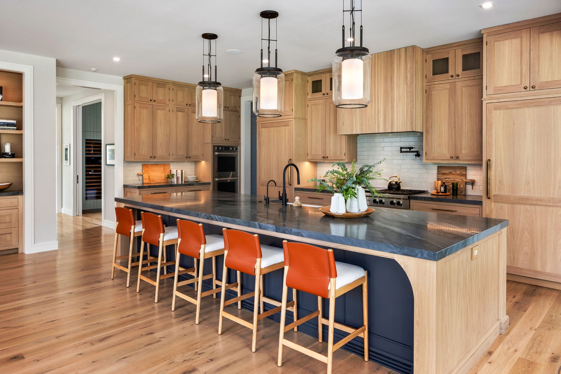 Kitchen with a long island and leather stools