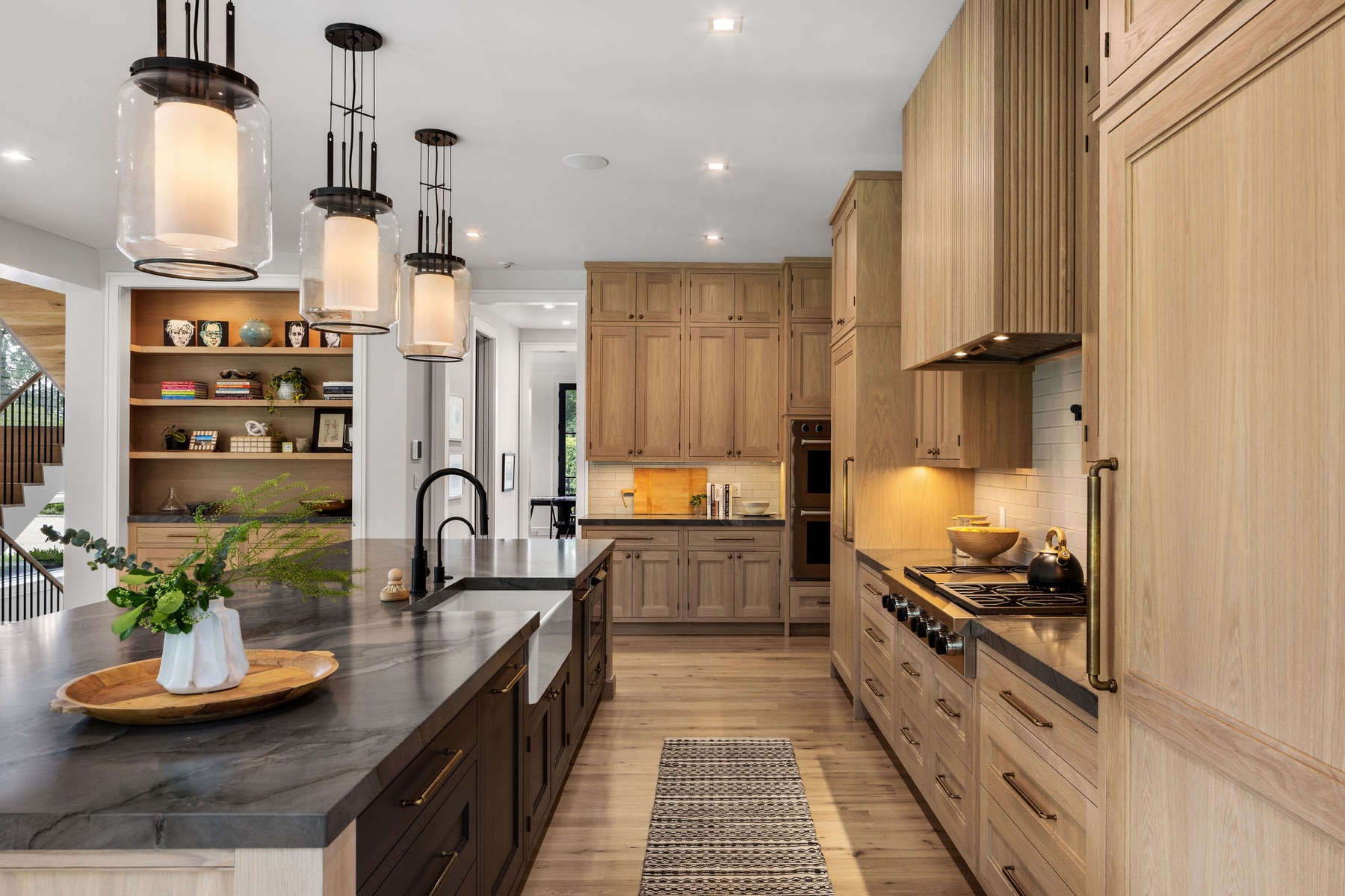 Oak kitchen with pendant lights and a farmhouse sink