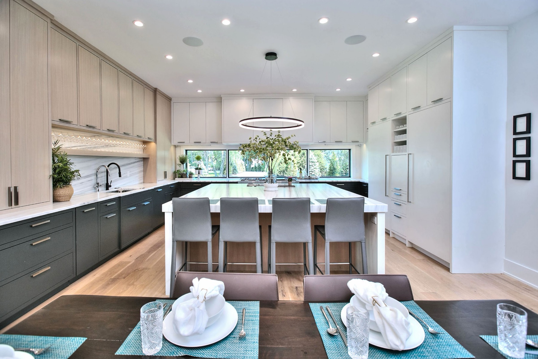 White kitchen with marble island and bar seating