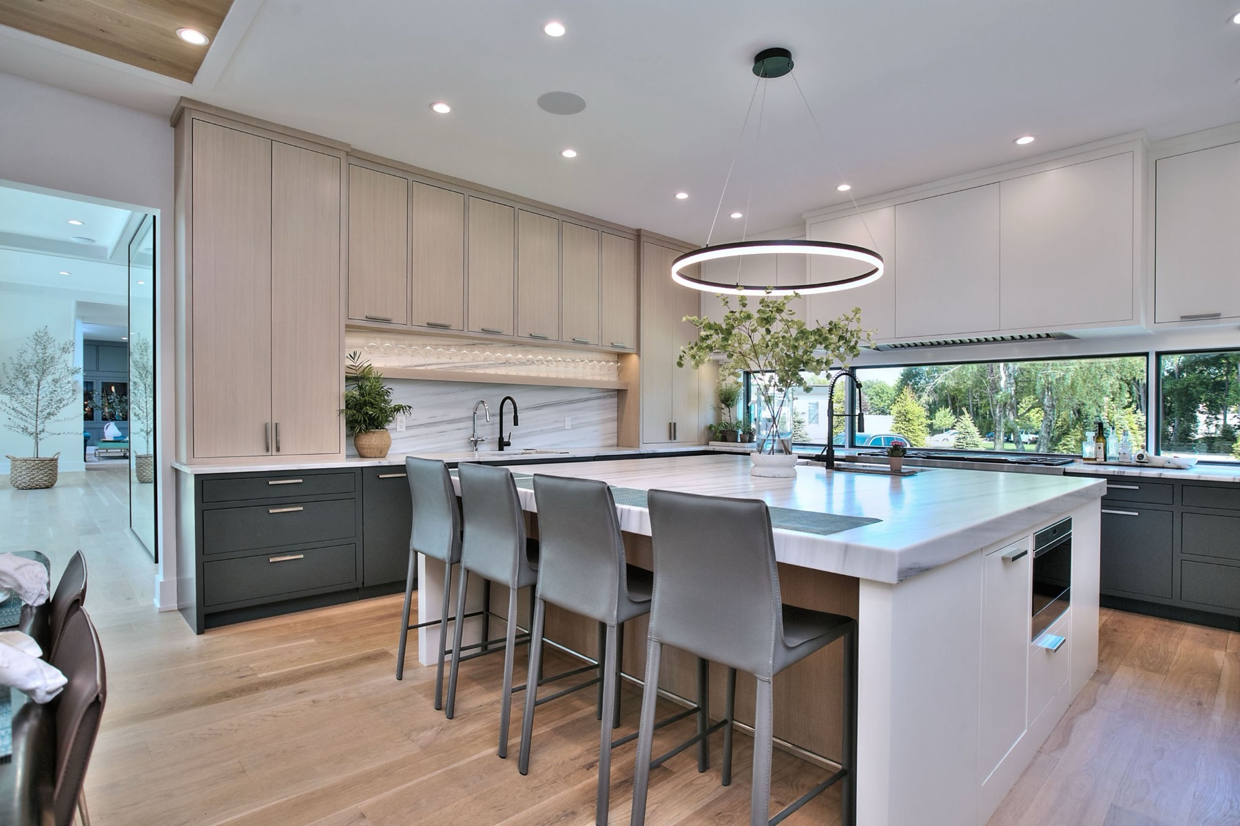 White kitchen with a ring chandelier over the island