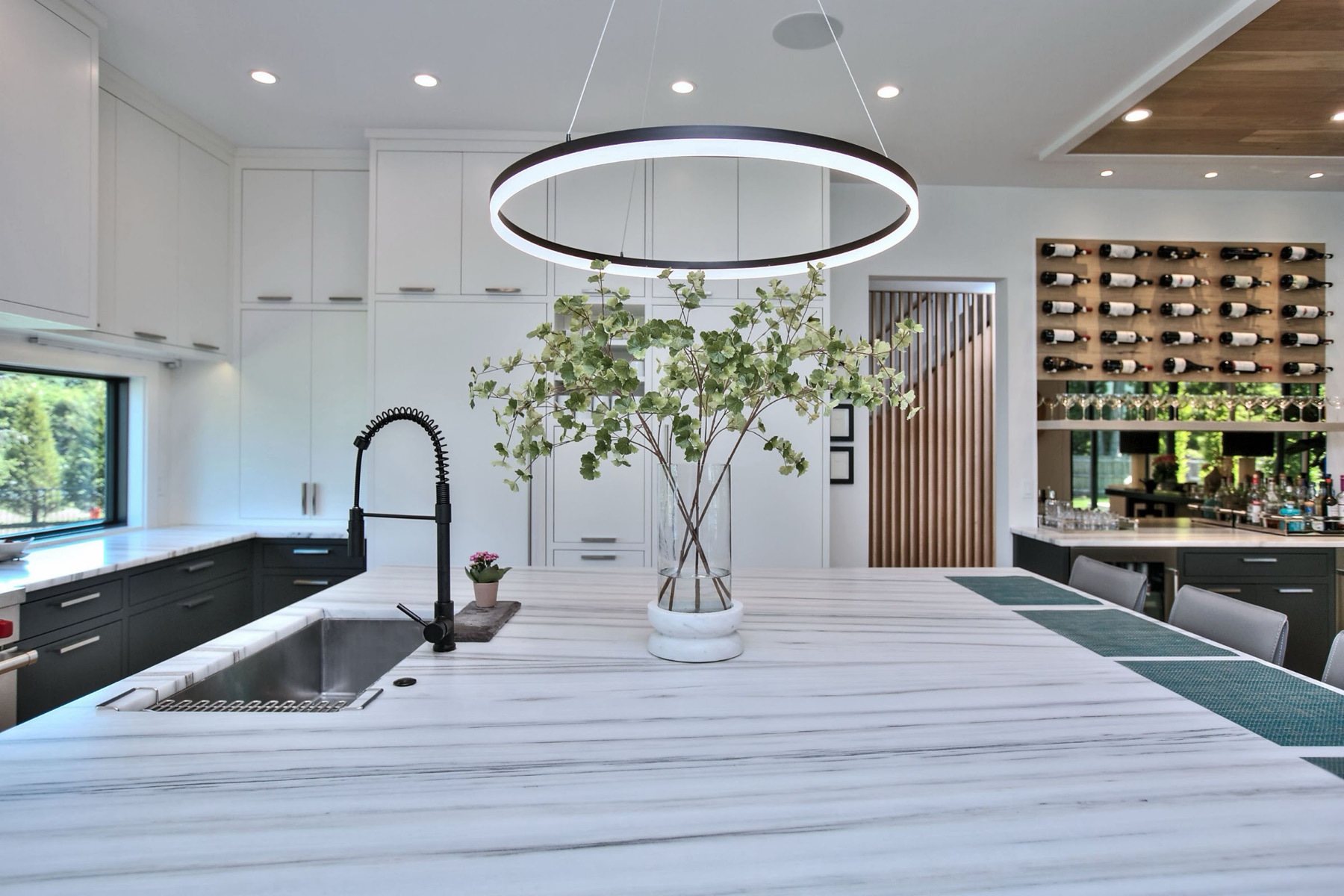 Kitchen with a ring light and a wine wall